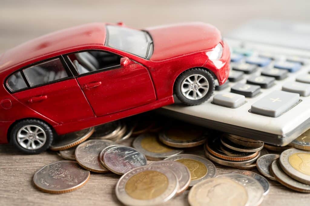 Car with coin and book bank for loan finance payment.